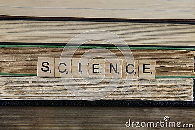 View on stacked old books with word science focus on center Editorial Stock Photo