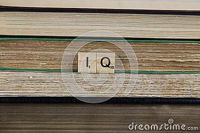 View on stacked old paper books with word IQ focus on center Editorial Stock Photo