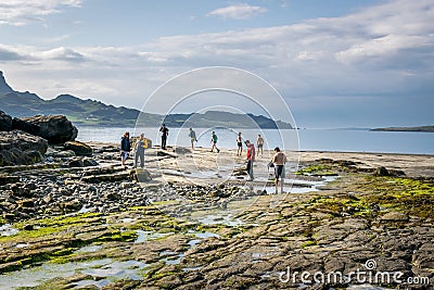 A view of Staffin island and Staffin harbour. Garrafad bay and An Corran Beach. People on the beach searching for dinosaur Stock Photo