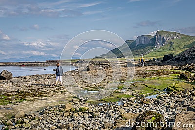 A view of Staffin island and Staffin harbour. Garrafad bay and An Corran Beach. People on the beach searching for dinosaur Editorial Stock Photo