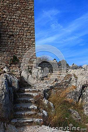 View of the staircase carved in stone and the remains of the tower of the fortress of Kritinia Stock Photo