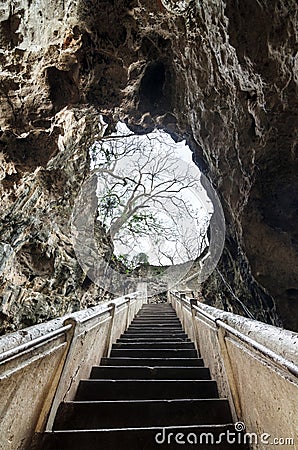 Stairs leading to the cave mouth of Tham Khao Luang temple cave, Phetchaburi, Thailand Stock Photo