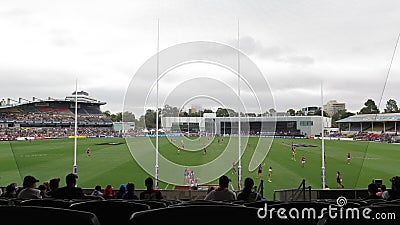 View from the stands behind the goal post line during a footy game at Ikon Park Stadium Editorial Stock Photo