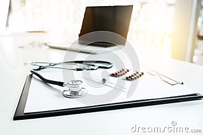 View of stethoscope, drug and equipment on foreground table with Stock Photo