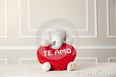 View of a stuffed elephant holding a heart with Te Amo writing on it - valentine's concept Stock Photo