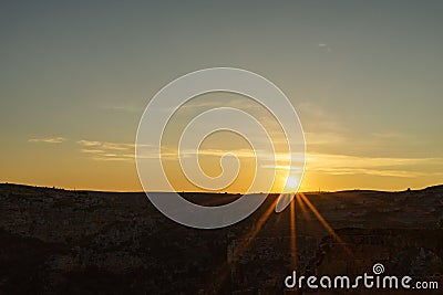 View of the sunrise with meadow stone valley in Matera, south I Stock Photo