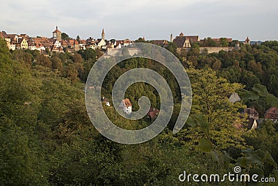 View of the Tauber valley and skyline of walled city in late afternoon light Stock Photo