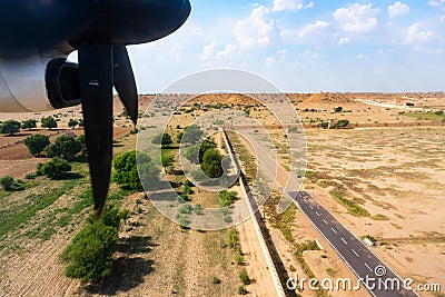 View of Thar desert from an aeroplane,Rajasthan, India. The propellers, the long runway of Jaisalmer airport and thar desert in Stock Photo