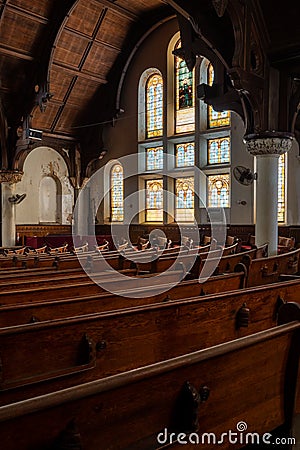 Derelict Wood Pews & Tiffany Stained Glass Windows - Abandoned McDowell Memorial Presbyterian Church - Philadelphia, Pennsylvania Stock Photo