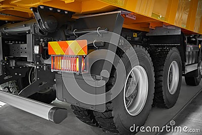 View on tipper truck chassis back, wheels and tires, rear red lights. New truck rear wheels. Special commercial transport for diff Stock Photo