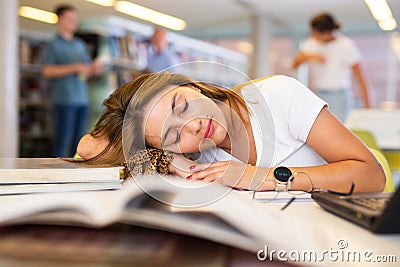 View on tired young Latina female student sleeping Stock Photo