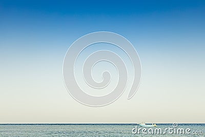 View to alone blue boat or ship yacht in silent sea or ocean water Stock Photo