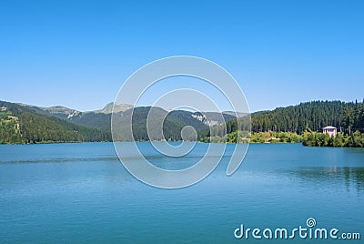 A view to Bolboci lake from the damb with carpathian mountains a Stock Photo