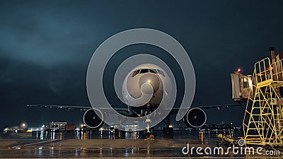 View to the cockpit and engines of parked airliner in airport at night Editorial Stock Photo