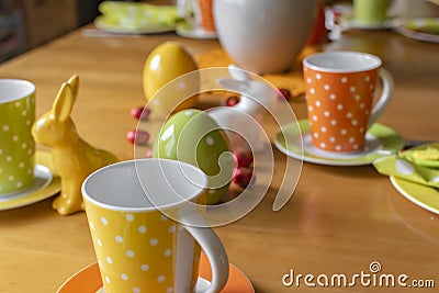 View to a colorful easygoing family breakfast table decorated for Easter Stock Photo