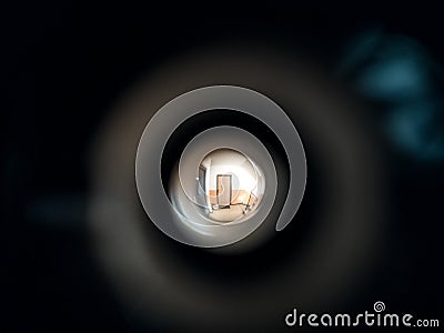 View to the hall through peephole eyelet in the door. Stock Photo