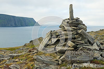View to the Mageroya Cape and sea with the stack of stones at the fore ground in North Cape, norway. Stock Photo