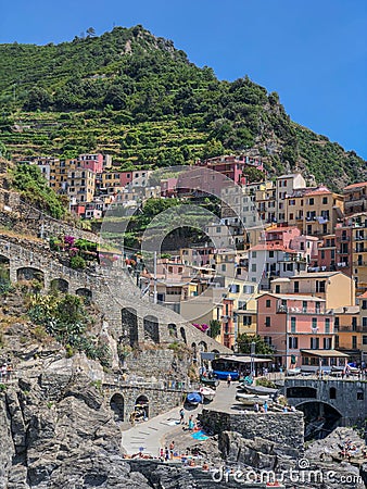 View to Manarola city, one of the towns of Cinque Terre five lands protected by UNESCO. Colorful houses and green hills Editorial Stock Photo