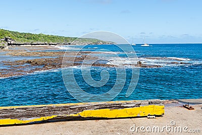 View to moored yachts beyond reef , Niue. Stock Photo