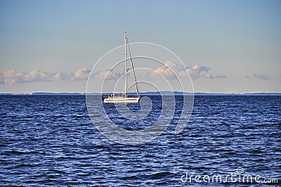 View to a sailing boat at the Greifswalder Bodden at the Baltic Sea Editorial Stock Photo