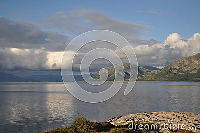View to the sea and mountains in Torget island in BrÃ¸nnÃ¸y, Nordland on summer evening Stock Photo