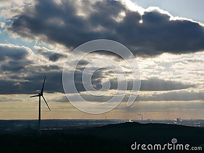 View to the still very industrial Ruhr area, with a wind turbine, from the Hoheward coal heap. A popular excursion destination Stock Photo