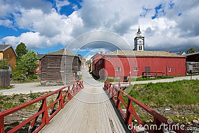 View to the traditional wooden houses, bridge and church bell tower of the copper mines town of Roros in Roros, Norway. Editorial Stock Photo