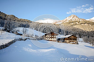 View to a winter landscape with old farmhouse and mountain range, Gasteinertal valley near Bad Gastein, Pongau Alps - Salzburg Aus Stock Photo