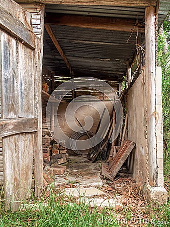 View of the tools and assorted objects in a rustic and very deteriorated small shed Stock Photo