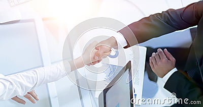 View from the top. handshake the senior Manager and the employee above the Desk Stock Photo