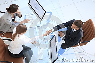 View from the top. handshake the senior Manager and the employee above the Desk Stock Photo