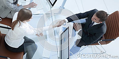 View from the top. handshake the senior Manager and the employee above the Desk Stock Photo