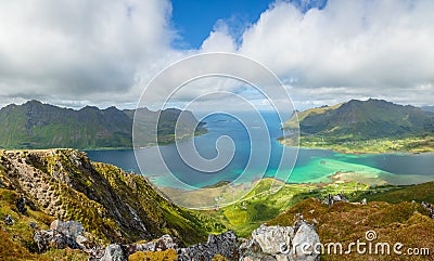 View from the top of Kleppstadheia mountain to the bay with turquoise water, and Rystad and Toe villages on the shores Austvagoya Stock Photo