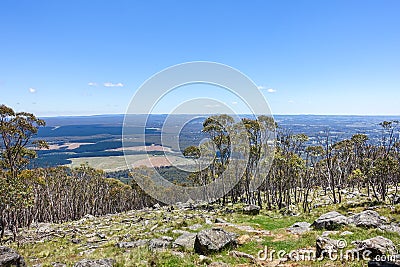 View from the top of Mount Macedon. Typical Australian landscape with woods, farmland and mountains in distance. Stock Photo