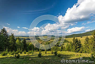 View from the top of the mountain, small hungarian village in the valley in Transylvania Stock Photo