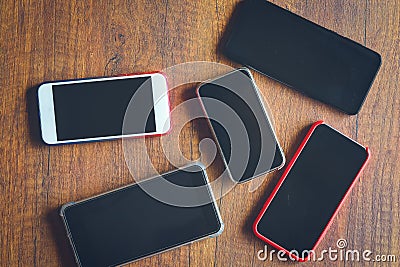Many mobile phones on the wooden table Stock Photo