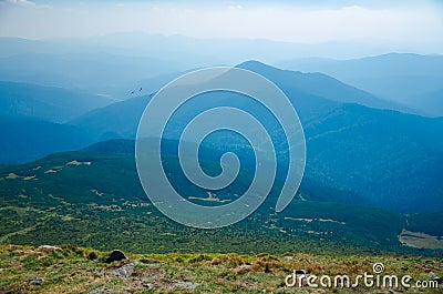 View from the top to the mountains in sunny weather Stock Photo