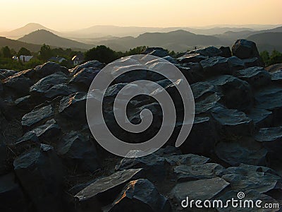 View from the tops of the surface of the basalt rock on the Bohemian Central Mountains at sunset. Stock Photo