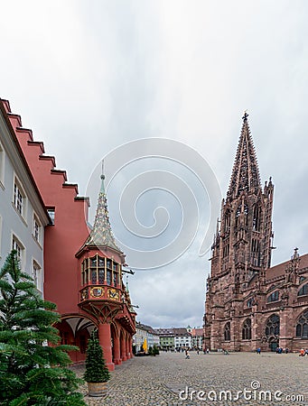 View of tourists visiting the cathedral and minster in Freiburg in the Breisgau Editorial Stock Photo