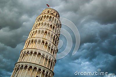 View of the tower of Pisa from below and dramatic cloud sky Stock Photo