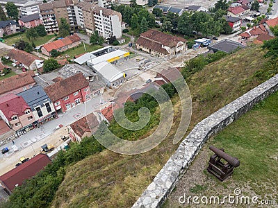 View of the town of Doboj, street bellow Gradina fortress on the hill above the town with medieval cannon Editorial Stock Photo