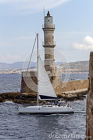 View of the town lighthouse, yacht and the sea Editorial Stock Photo