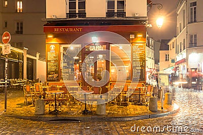 View of traditional parisian vintage restaurant at rainy evening Editorial Stock Photo