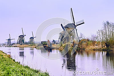 View of traditional 18th century windmills and water canal in Kinderdijk, Holland, Netherlands Stock Photo