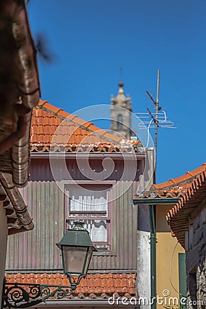 View at a traditional urban buildings on Porto downtown, blurred Clerigos tower on background Editorial Stock Photo