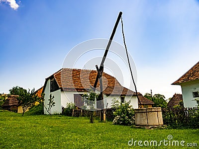 View on a traditional well and hungarian pise houses in Szentendre Editorial Stock Photo