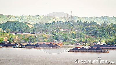 View of traffic of tugboats pulling barge of coal at Mahakam River, Samarinda, Indonesia. Editorial Stock Photo