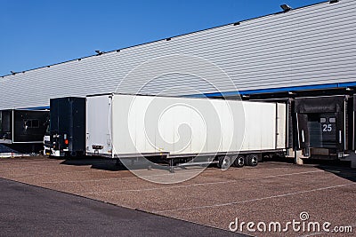 View of trailers in front of loading doors at a warehouse Stock Photo