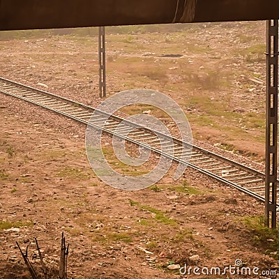 View of train Railway Tracks from the middle during daytime at Kathgodam railway station in India, Train railway track view, Stock Photo