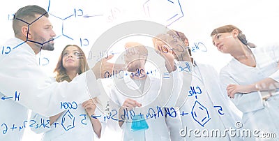 View through the transparent Board. a group of scientists analyze information. Stock Photo